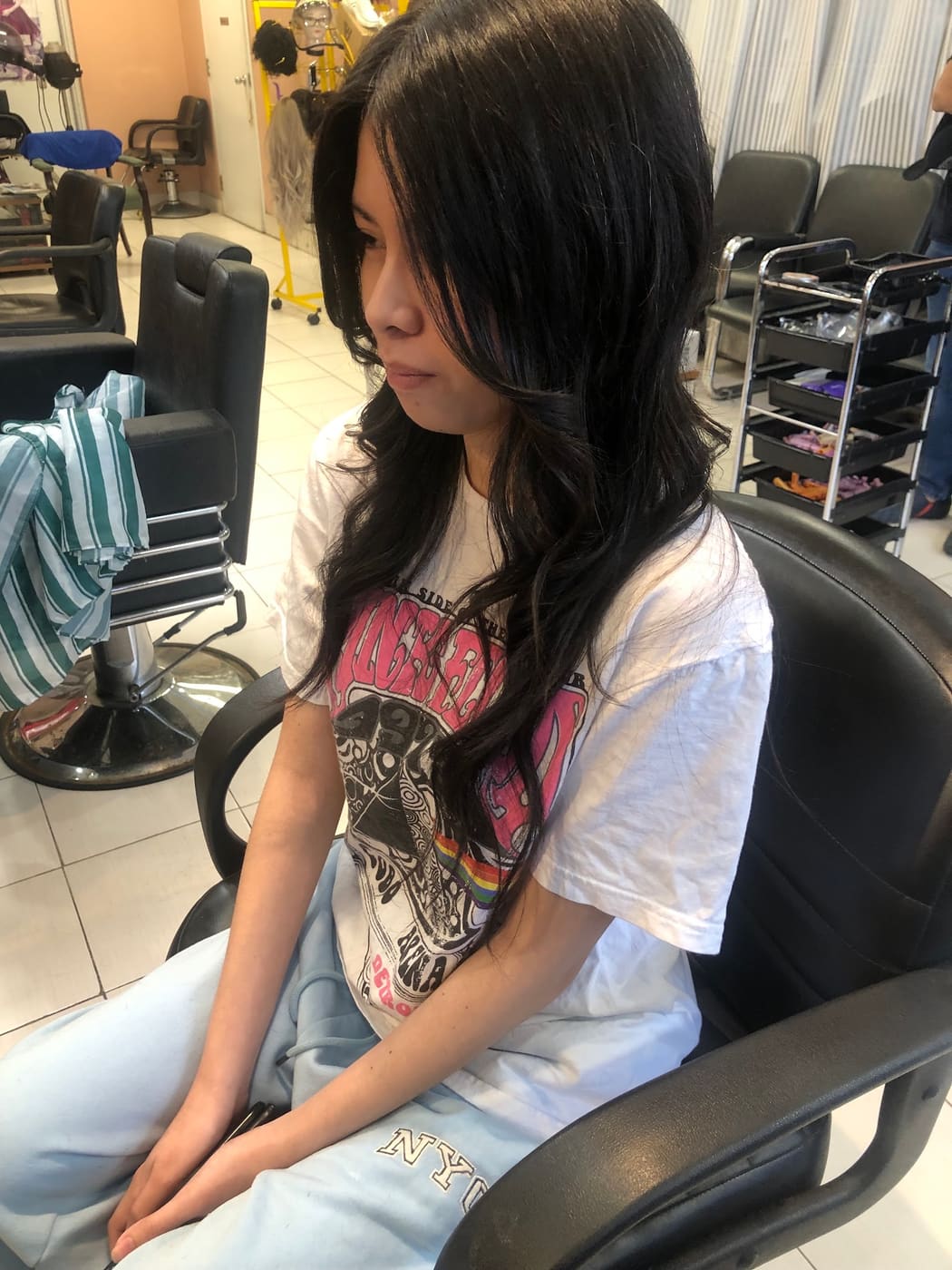 Long dark hair styled in the salon chair